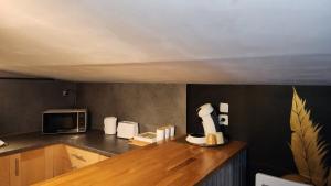 a kitchen with a counter top with a microwave at Jolie maison de campagne - Morisel in Morisel