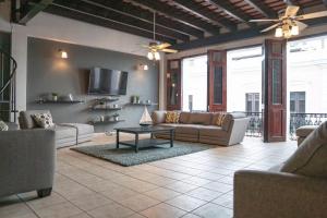 a living room with two couches and a tv at Spacious & Modern Colonial PH Apt in Old San Juan in San Juan