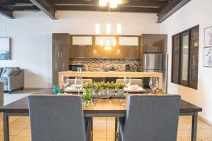 a dining room with a wooden table and chairs at Spacious & Modern Colonial PH Apt in Old San Juan in San Juan