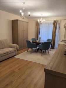 a living room with a dining room table and chairs at Bloom Apartament in Alba Iulia