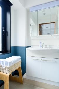 a bathroom with a white sink and a mirror at Ueno Woo Hotel in Tokyo