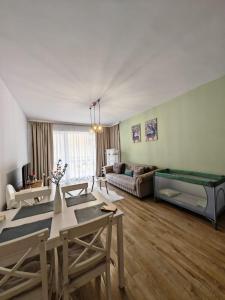 a living room with a table and a couch at Apartament Panoramic View Sinaia in Sinaia
