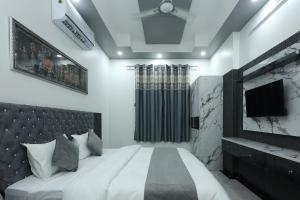 Singh Villa Udaipur في أودايبور: غرفة نوم بسرير كبير وتلفزيون