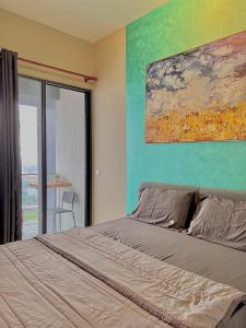 um quarto com uma cama e um quadro na parede em KLCity 1BR Apartment SkyLounge em Kuala Lumpur