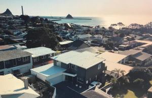 an aerial view of a city with houses and the ocean at Saint Aubyn Retreat in New Plymouth