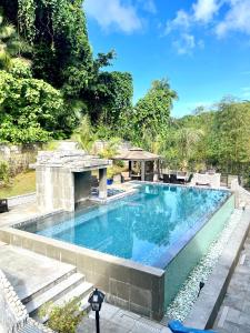 a swimming pool in the middle of a resort at Ngermid Oasis - Studio W/ Kitchenette & Pool View in Koror