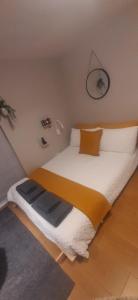 a bedroom with a large bed in a room at Alross studio flat / private bathroom in London
