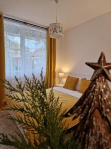 a bedroom with a bed and a christmas tree at MV Central Apartment & Garage - Self Check-in in Timişoara