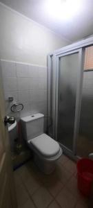 a small bathroom with a toilet and a shower at Sorrento Oasis 2 BR in Manila