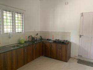 a kitchen with a sink and a counter top at Casa Ganesha beach residence in Irimbranallūr