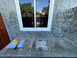 a kitchen sink with a window above it at PP Pool Villa Maesalong Chiangrai in Mae Salong Nai