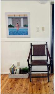 a chair sitting in a room with a swimming pool at ハルク キャビン in Nakijin