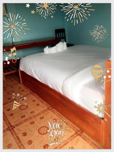 a bed in a room with fireworks on the wall at MR Mo Guest House in Muang Không