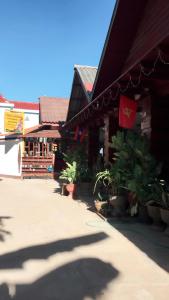 a building with potted plants in front of it at MR Mo Guest House in Muang Không