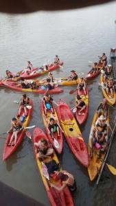 a group of people in kayaks in the water at MR Mo Guest House in Muang Không