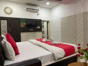 a bedroom with a large bed with two swans on it at Hotel Pratap Palace in Bharatpur