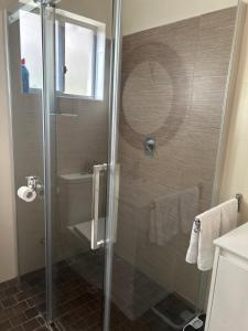 a shower with a glass door in a bathroom at Koombana Retreat in Perth +18 photos