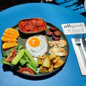 a plate of breakfast food on a blue table at Villa Pamuklu second floor only in Çaykara