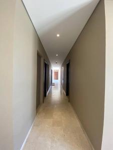 an empty hallway in a building with a ceiling at Lovely studio apartment inside Jebel Sifah resort in As Sīfah