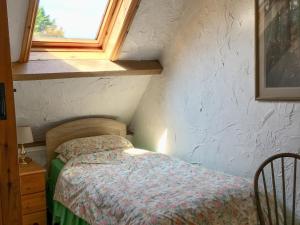 Dormitorio pequeño con cama en el ático en Little Whitnell Cottage, en Nether Stowey