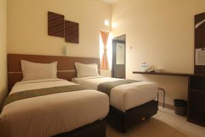 Tempat tidur dalam kamar di Hotel Pules