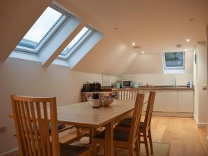 a dining room with a wooden table and skylights at Cottage No,2 - Uk41847 in Aberfeldy