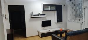 巴克烏的住宿－3 camere, zona linistita, parcare privata，一间客厅,在白色的墙上配有电视
