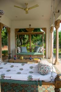 a living room with a bed and a couch at Naila Kothi, Jaipur in Jaipur