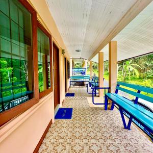 a hallway with benches and windows on a building at Chamil House (ชามิล เฮ้าส์) 