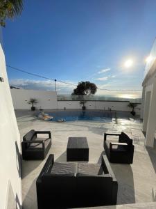 a patio with two couches and a pool at Villa Eleonor in Tangier