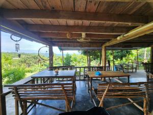 a patio with tables and chairs with a view at Sweet Nature Bungalow in Koh Rong Island