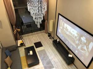 a living room with a flat screen tv and a living room at Meiju Apartment in Guangzhou