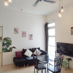 a living room with a couch and a table at 3Rooms 2BR SUNWAY NEXIS KOTA DAMANSARA in Petaling Jaya