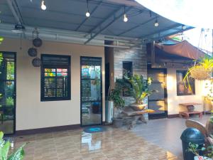a patio with potted plants in a building at Yana's Place in Donsol