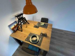 a wooden table with a light on top of it at Zechenbude - Erlebe das Ruhrgebiet in Gladbeck
