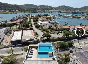 arial view of a city and a body of water at Hotel Samba Cabo Frio Flat in Cabo Frio