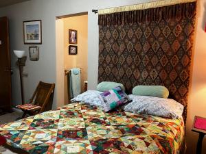 a bedroom with a bed with a quilt on it at Silver Valley Getaway in Kellogg