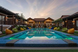a swimming pool in the middle of a house at Highland Bali Villas, Resort and Spa in Pantabangan