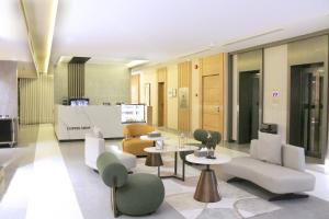 a lobby with chairs and tables in a building at Al Muhaidb Residence Al JAWAZAT 2 - Economic in Riyadh