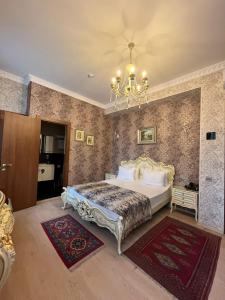 a bedroom with a bed and a chandelier at La Casa Old City Hotel in Baku