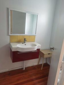 a bathroom with a sink and a mirror at Mt Eden Master Suite RM1 in Auckland