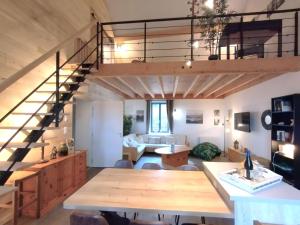 a living room with a staircase and a dining room at FORET in Saulieu