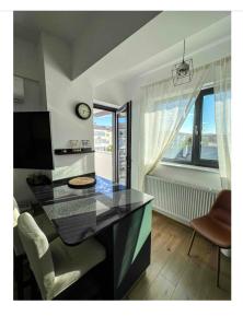 a room with a desk with a chair and a window at Scandinavian for you in Bacău +1 photo