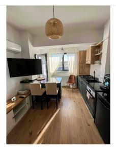 a kitchen with a table and a dining room at Scandinavian for you in Bacău