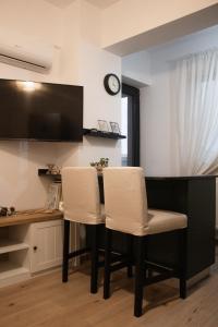 a dining room with a table and two white chairs at Scandinavian for you in Bacău