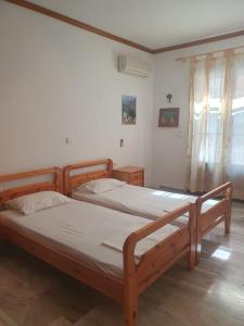 a bedroom with two wooden beds in a room at Haus Regina in Khrónia