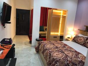 a hotel room with a bed and a television at S.K PLAZA in East Legon