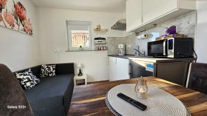 a living room with a couch and a table at Apartmaji STARS in Mavčiče