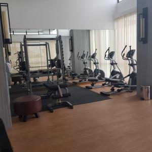 a gym with rows of treadmills and exercise bikes at One Residence #11AI in Batam Center