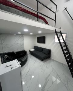 a living room with a loft bed and a black couch at LUIGI LUXURY SUITE in Naples